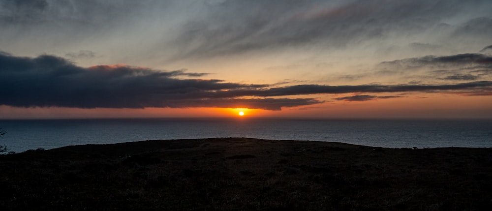 silhouette of mountain during sunset