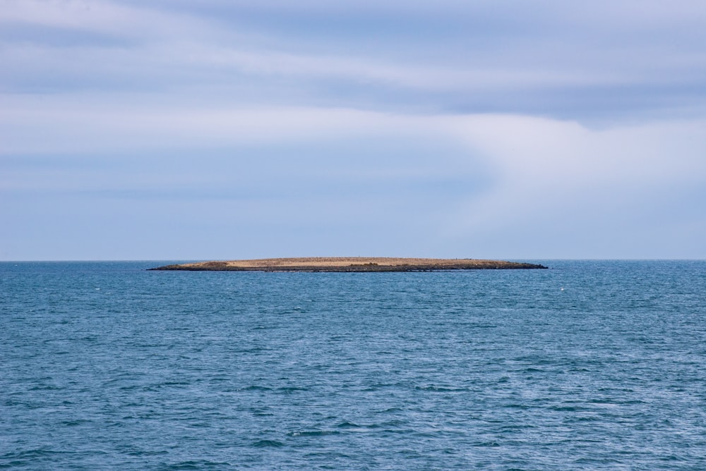 blue sea under white clouds during daytime