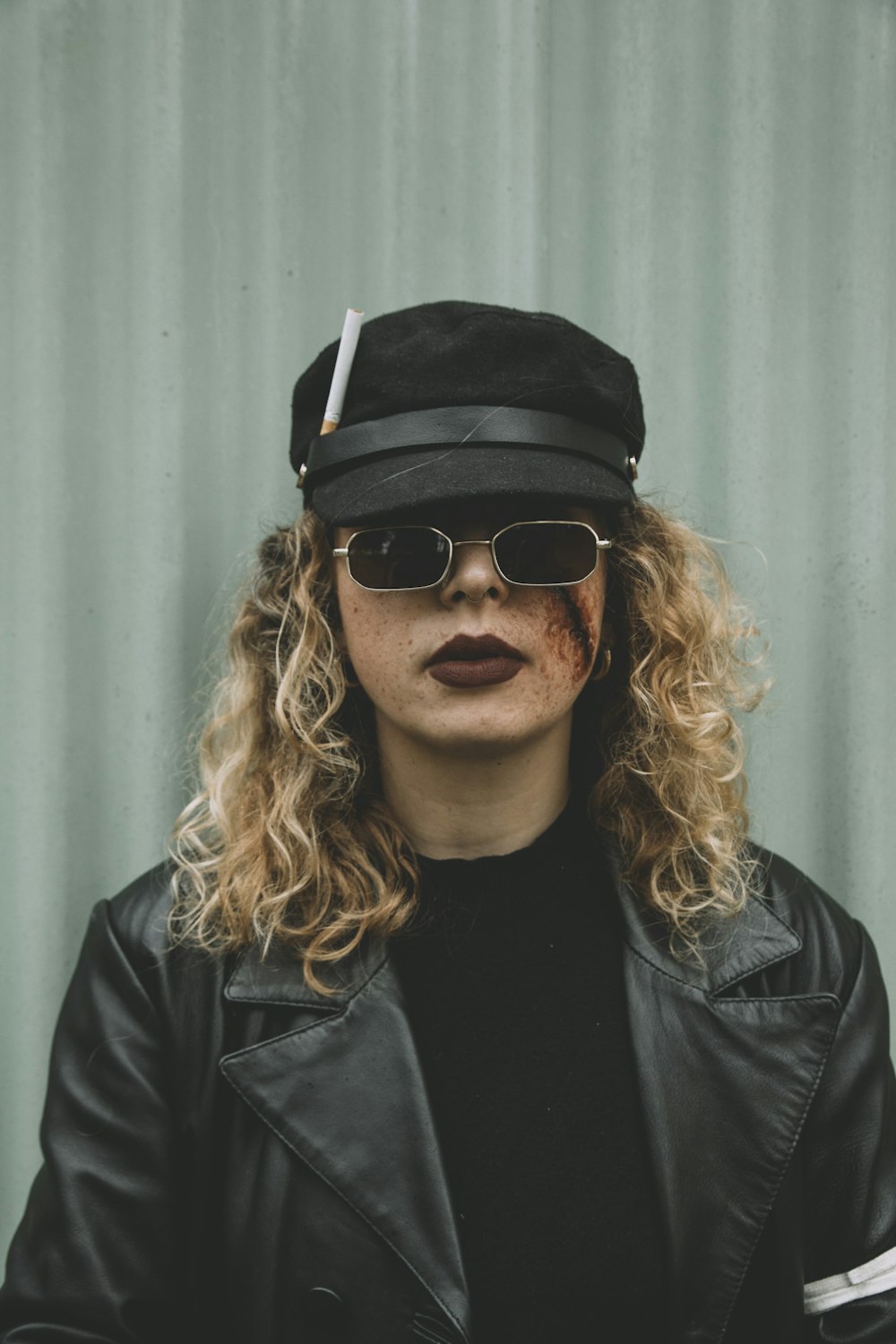 man in black leather jacket wearing black sunglasses