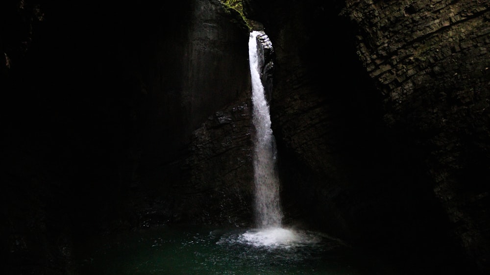 water falls in the middle of the forest