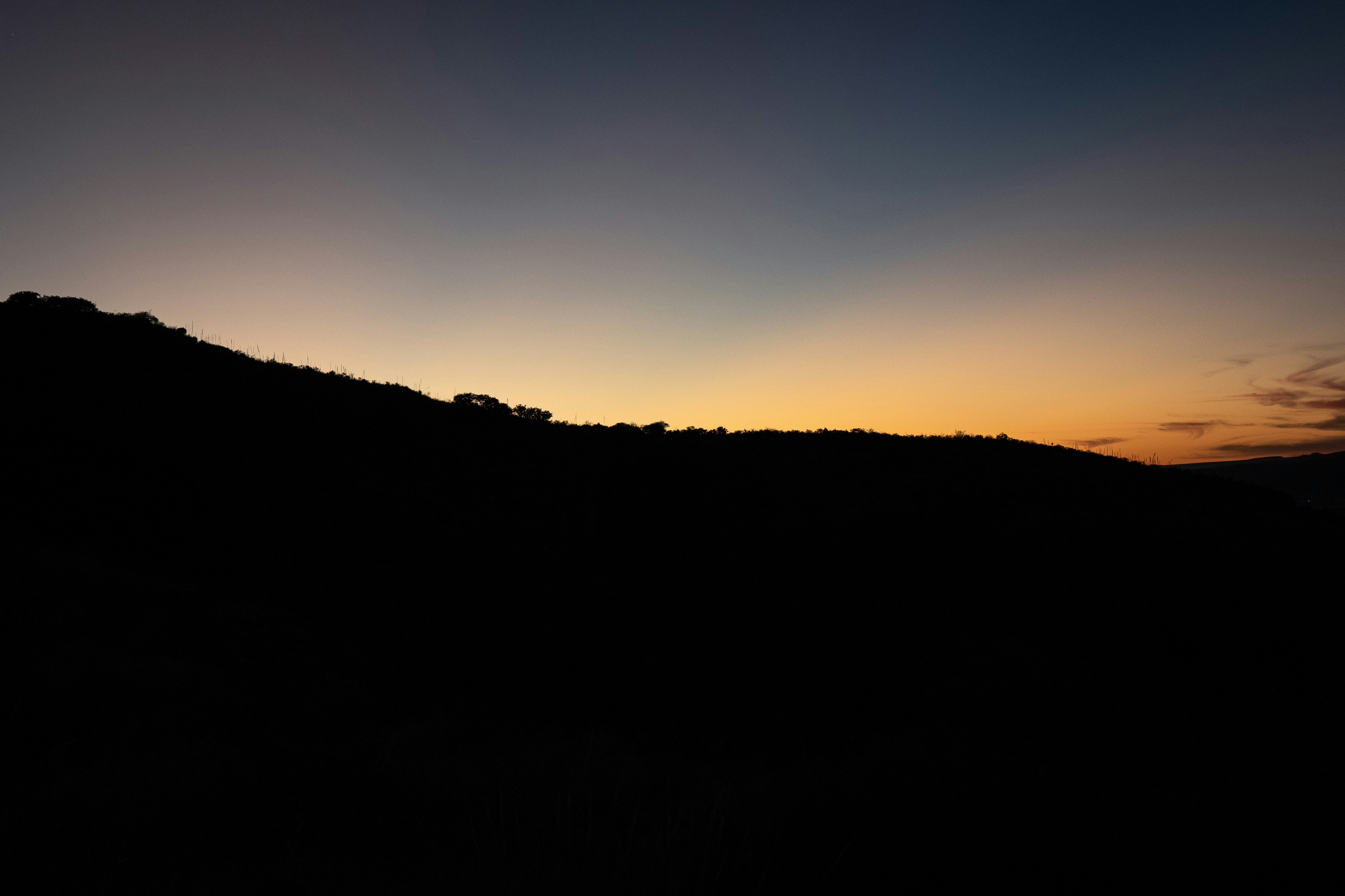 silhouette of mountain during sunset