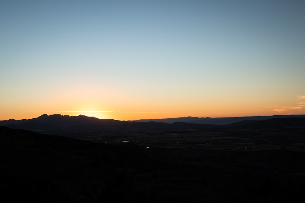 silhouette of mountain during sunset