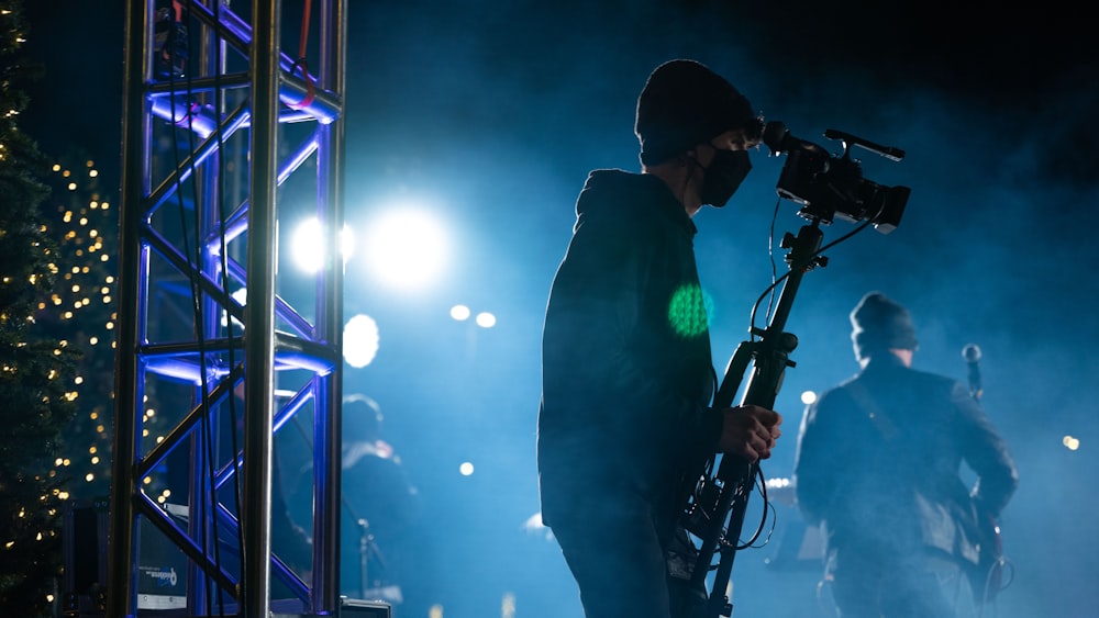 man in black jacket holding black microphone