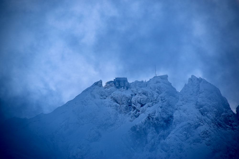 white and black mountain under white clouds