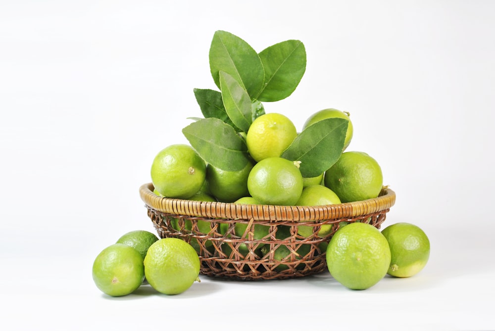 green apple fruit on brown woven basket