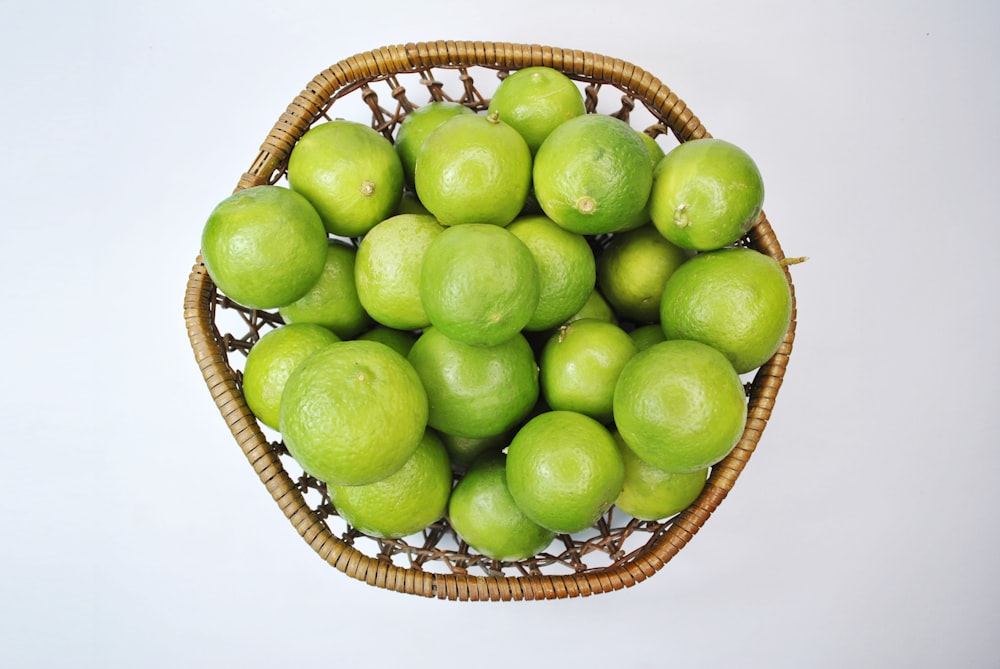 green apple fruit on brown woven basket