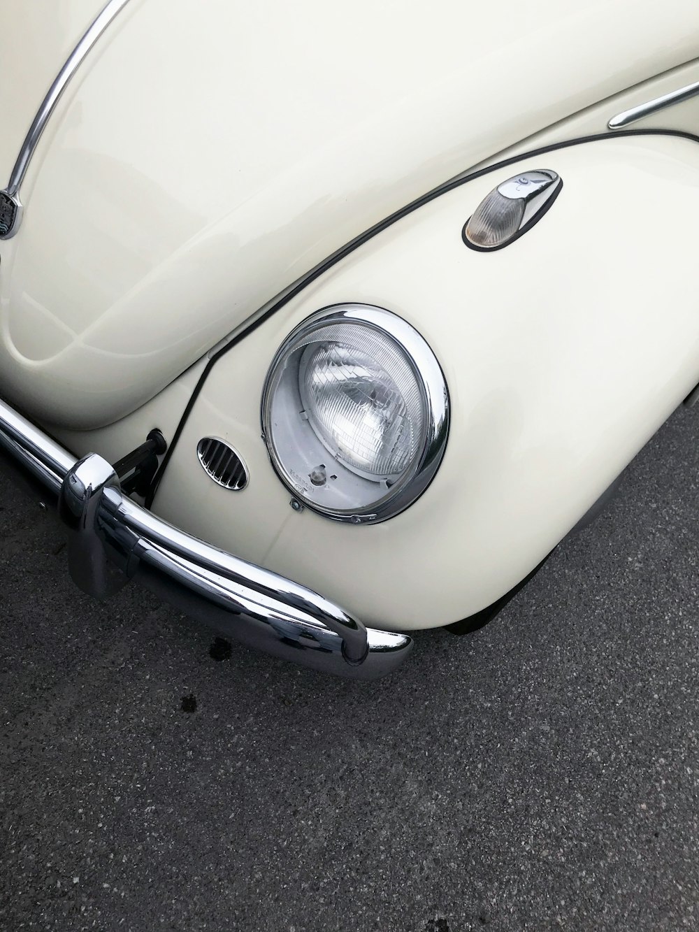 white volkswagen beetle on road during daytime