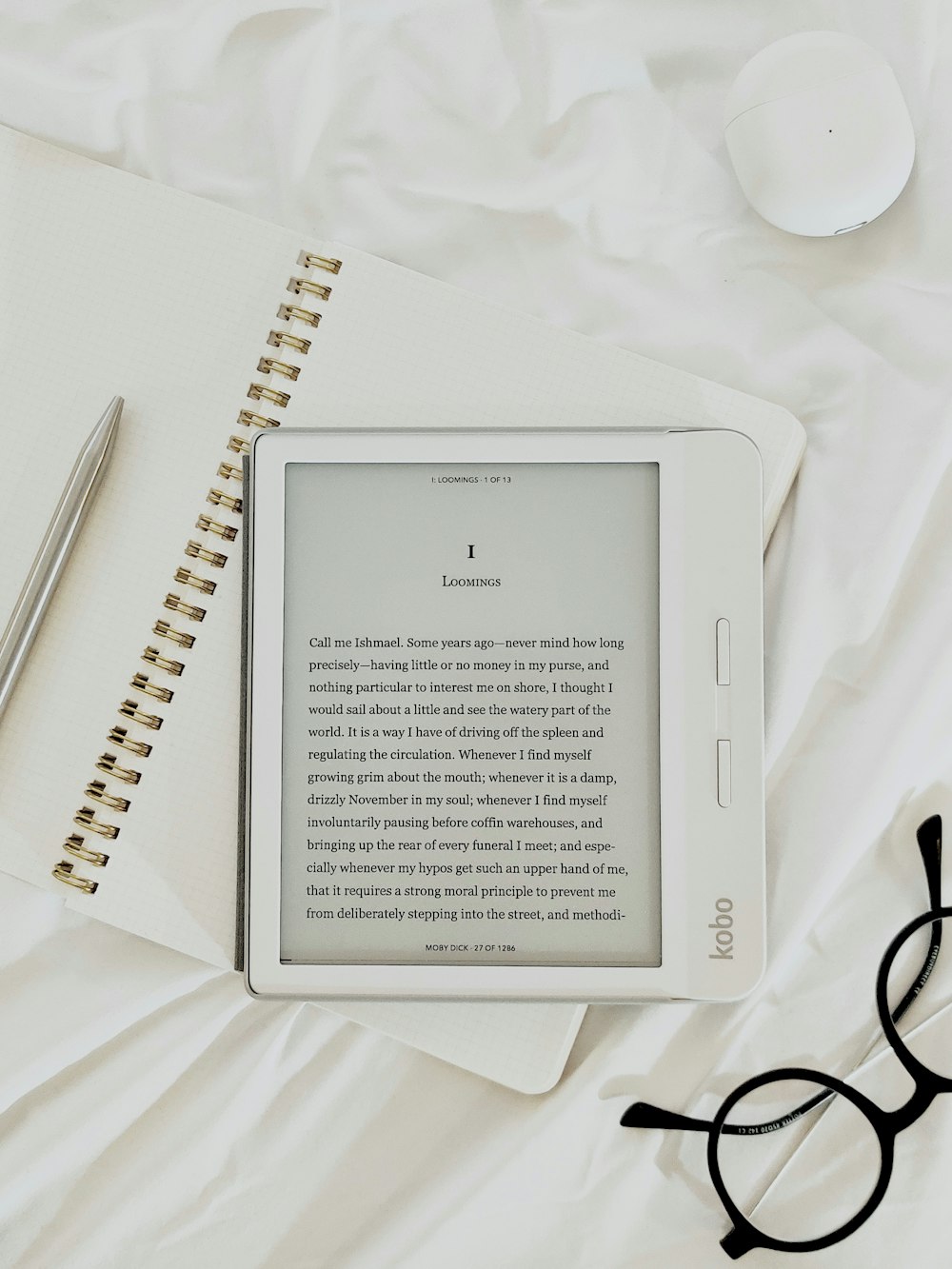 white book page on white textile - 6 simple ways to make reading apart of your daily routine