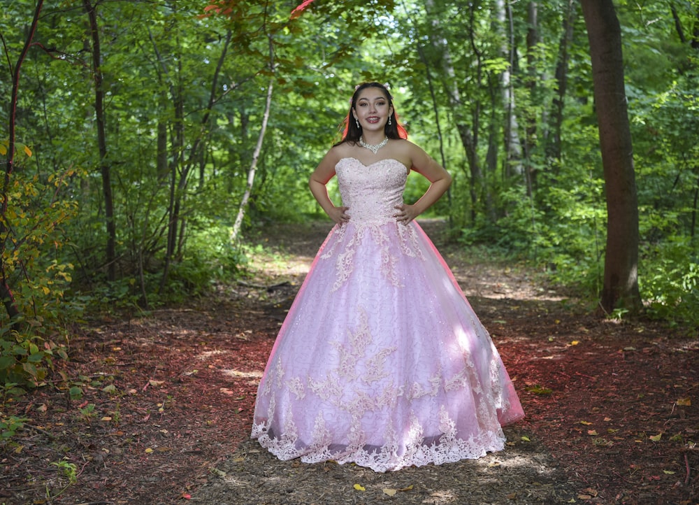 woman in white dress standing on forest during daytime