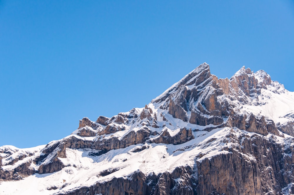 snow covered mountain under blue sky during daytime