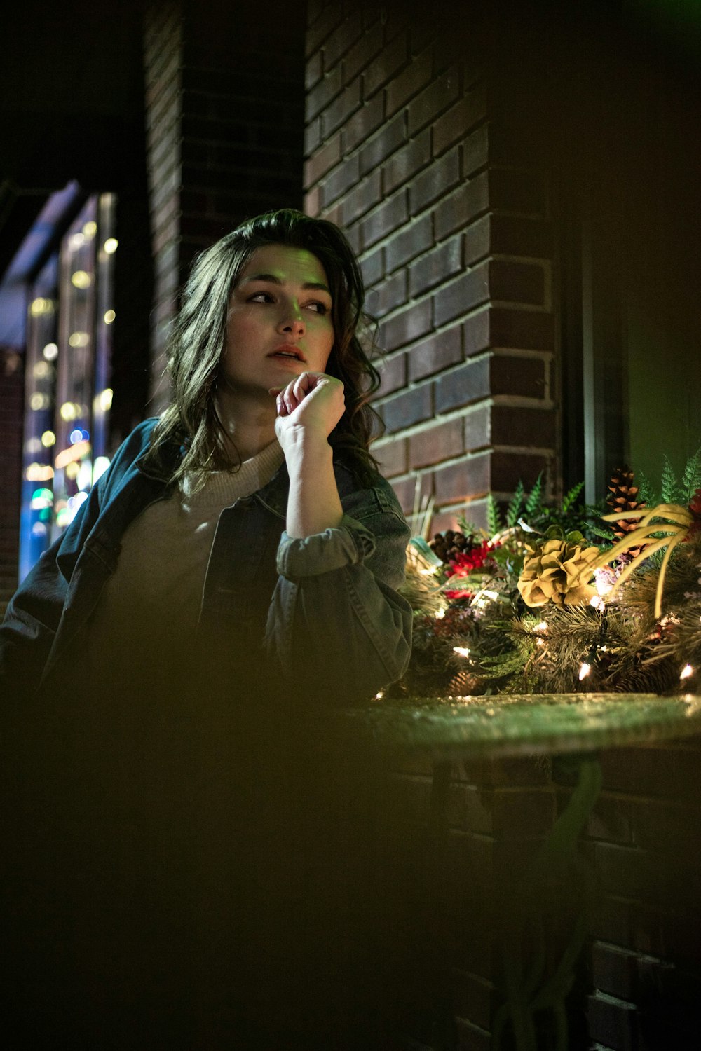 woman in white long sleeve shirt sitting on brown wooden bench