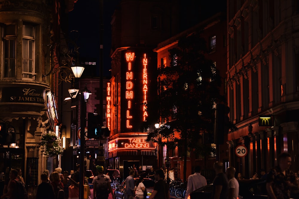 people walking on street during night time