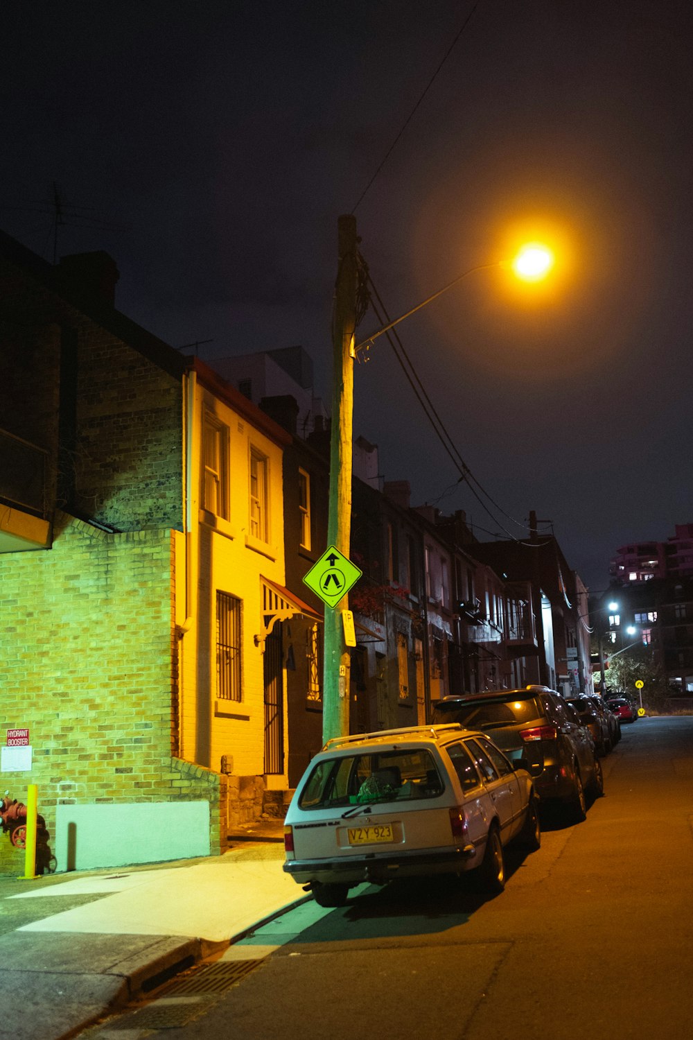 cars parked beside building during night time