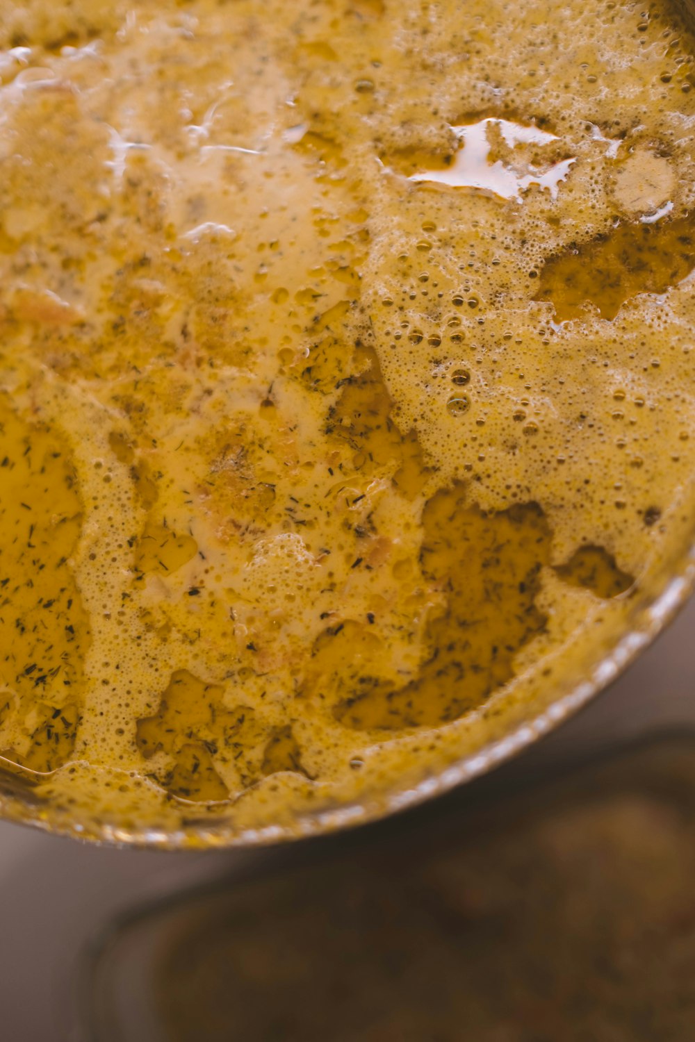 yellow liquid in stainless steel bowl