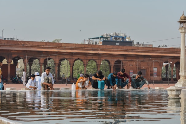 A group of pilgrims sharing a quiet moment of reflection near the Zamzam water station.