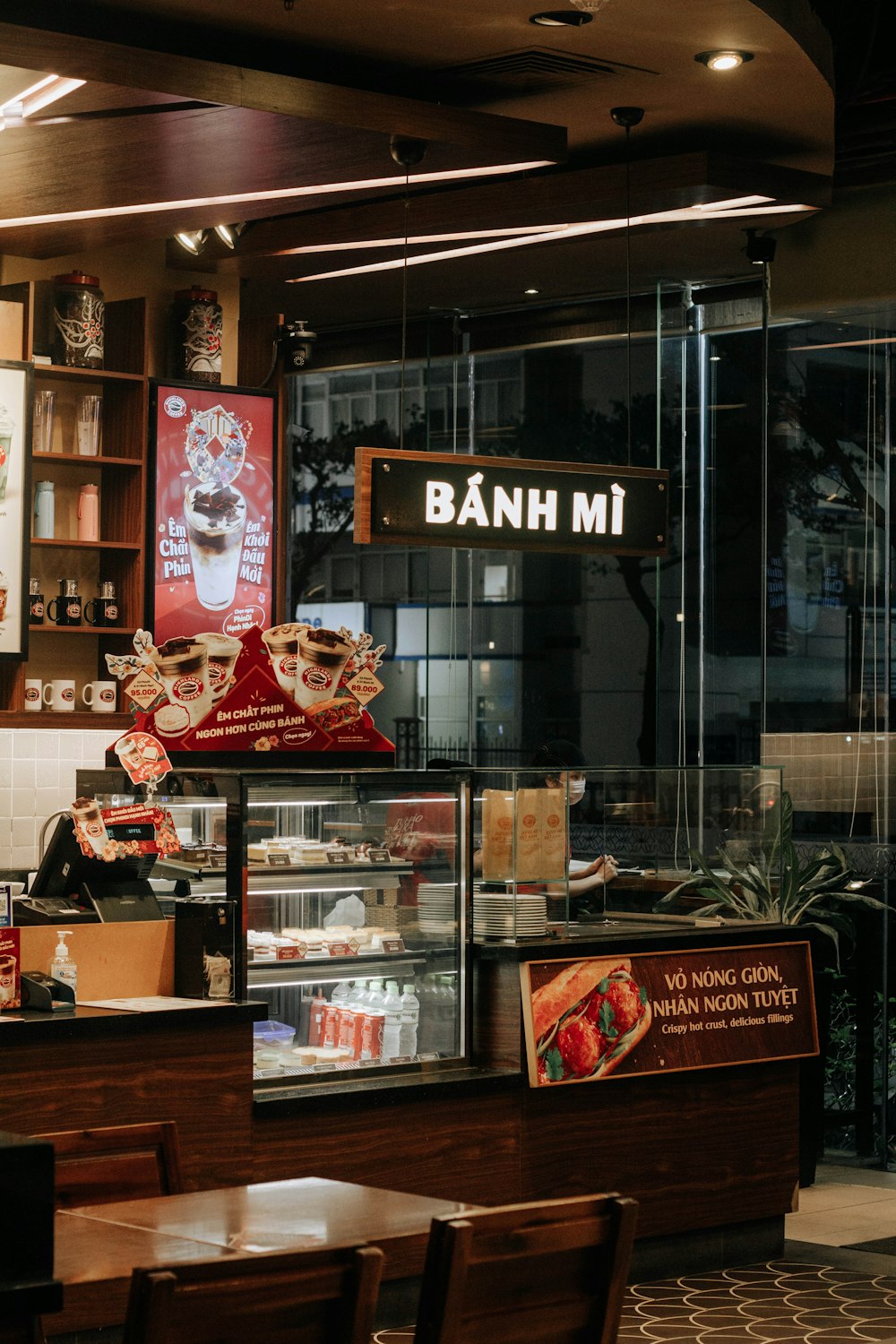 a restaurant with a bunch of food behind the counter