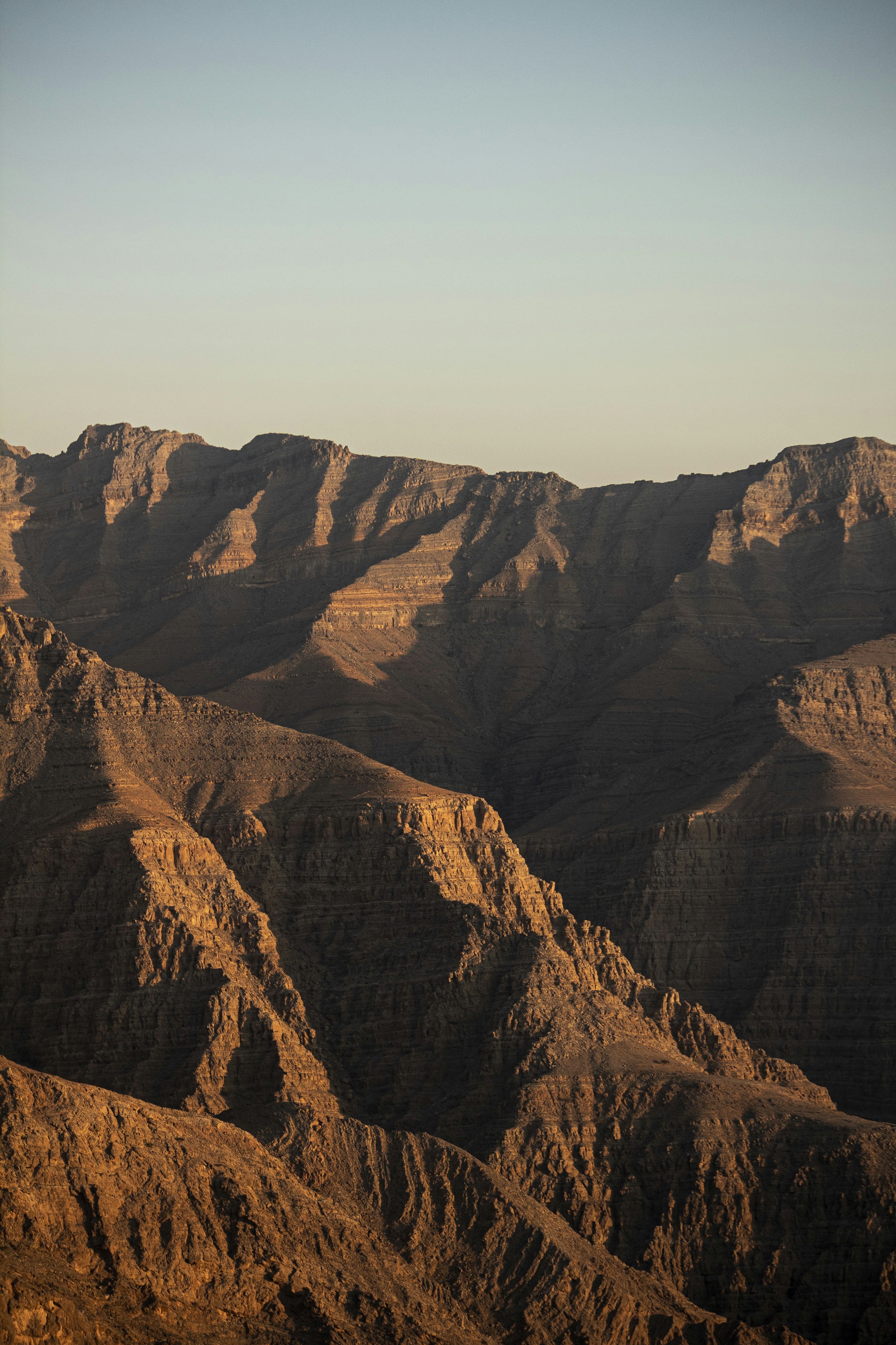 brown rocky mountain under blue sky during daytime