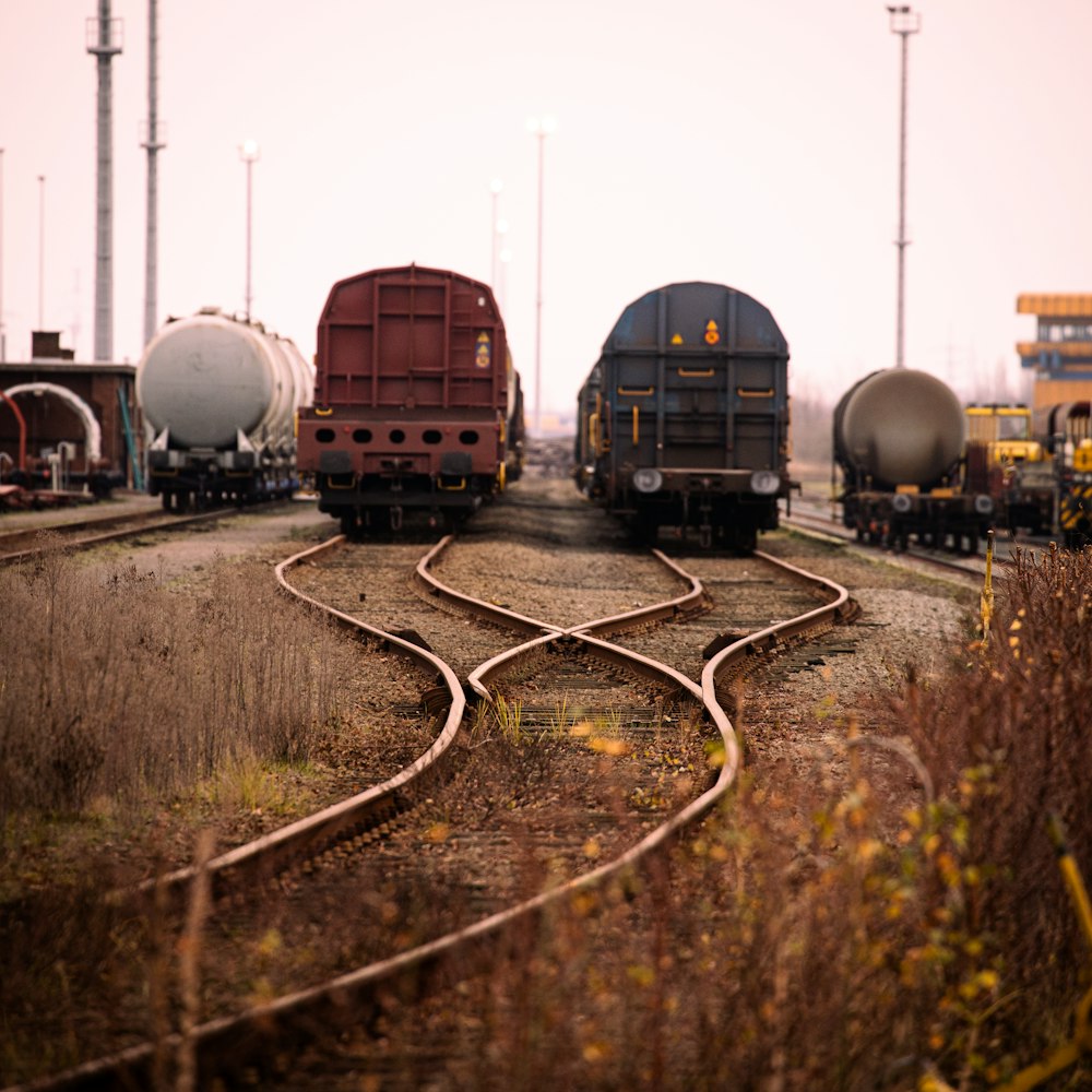 blue and black train on rail tracks during daytime