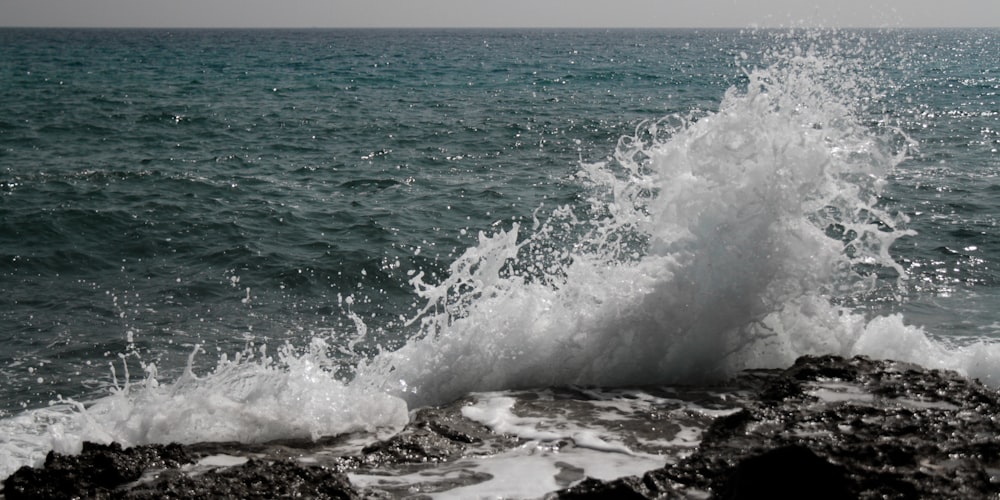 ocean waves crashing on shore during daytime