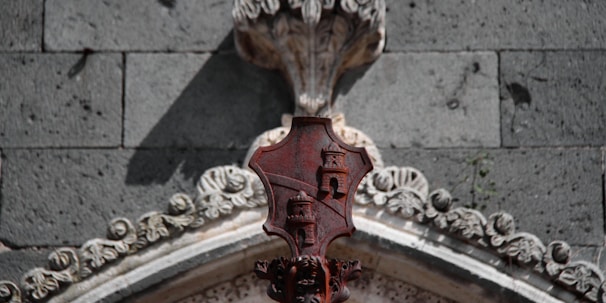 A detailed shot of a freemasonry emblem carved into old stone.