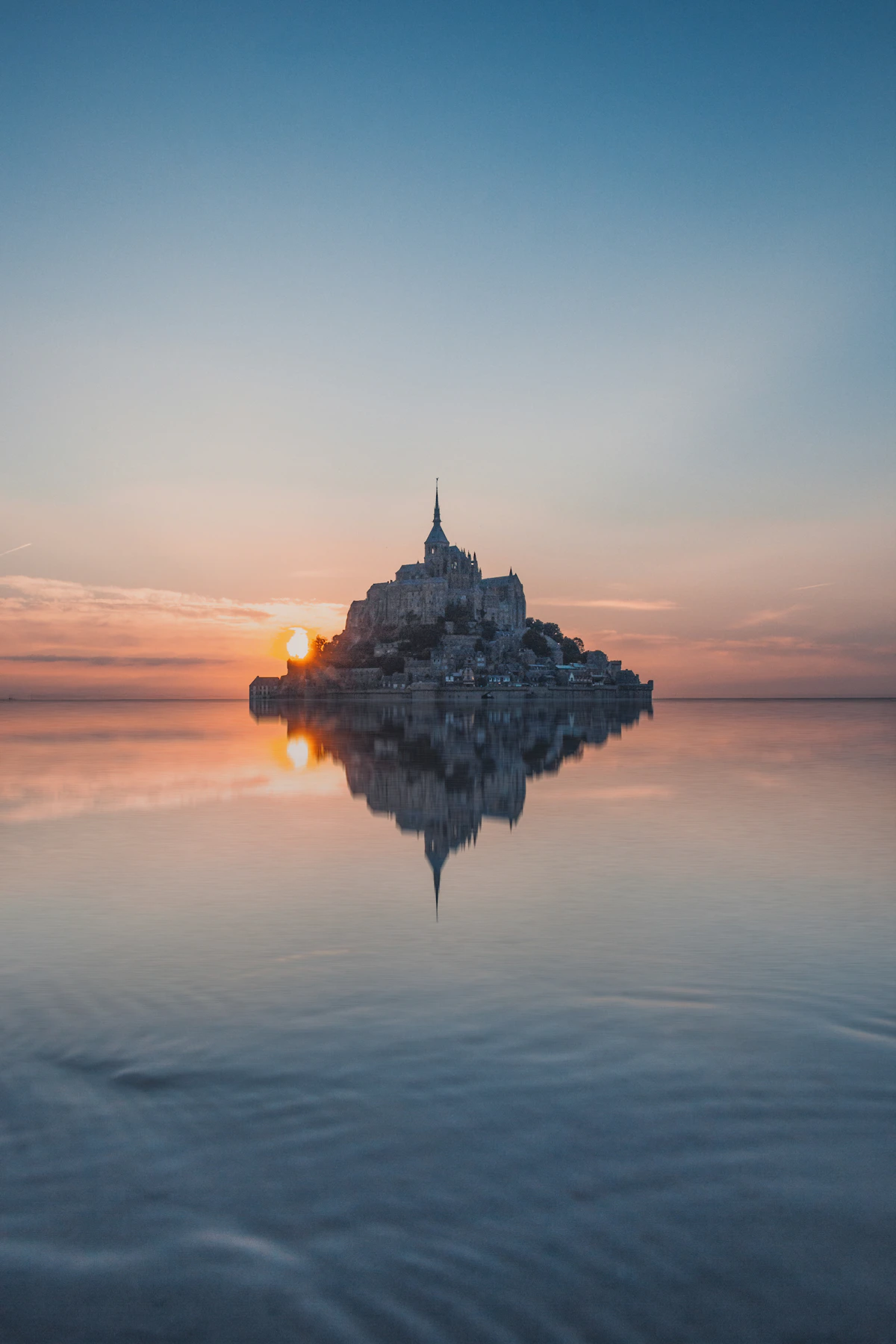 Mont-Saint-Michel at sunrise, reflected in the bay