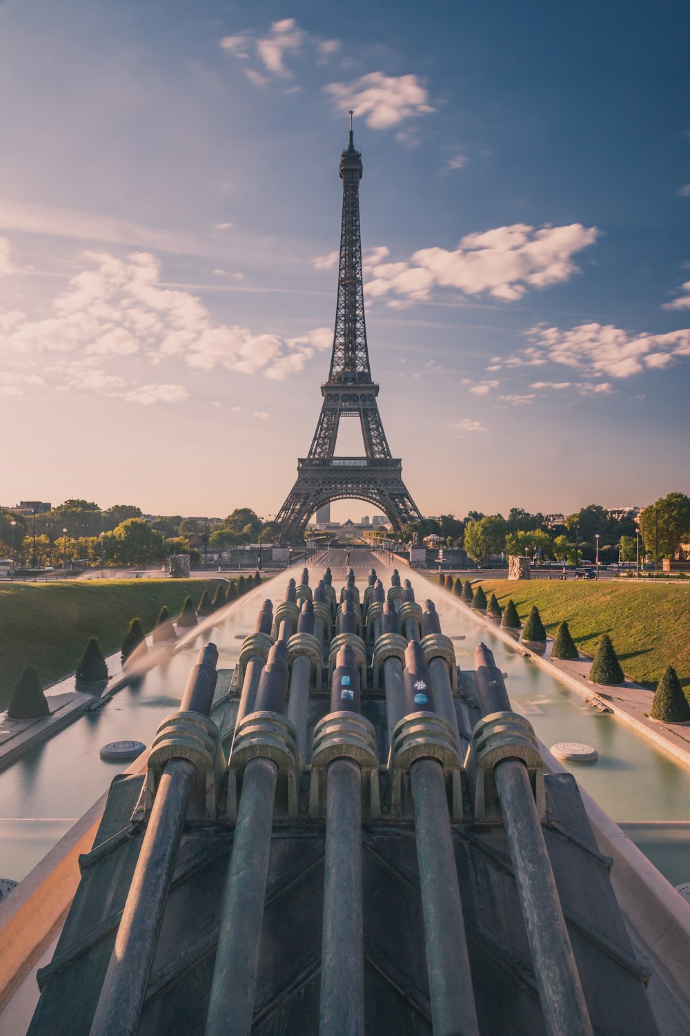 eiffel tower under white clouds and blue sky during daytime