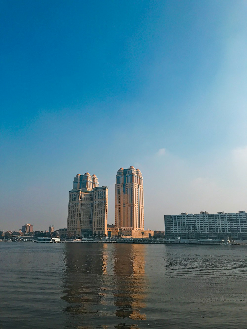 city skyline across body of water during daytime