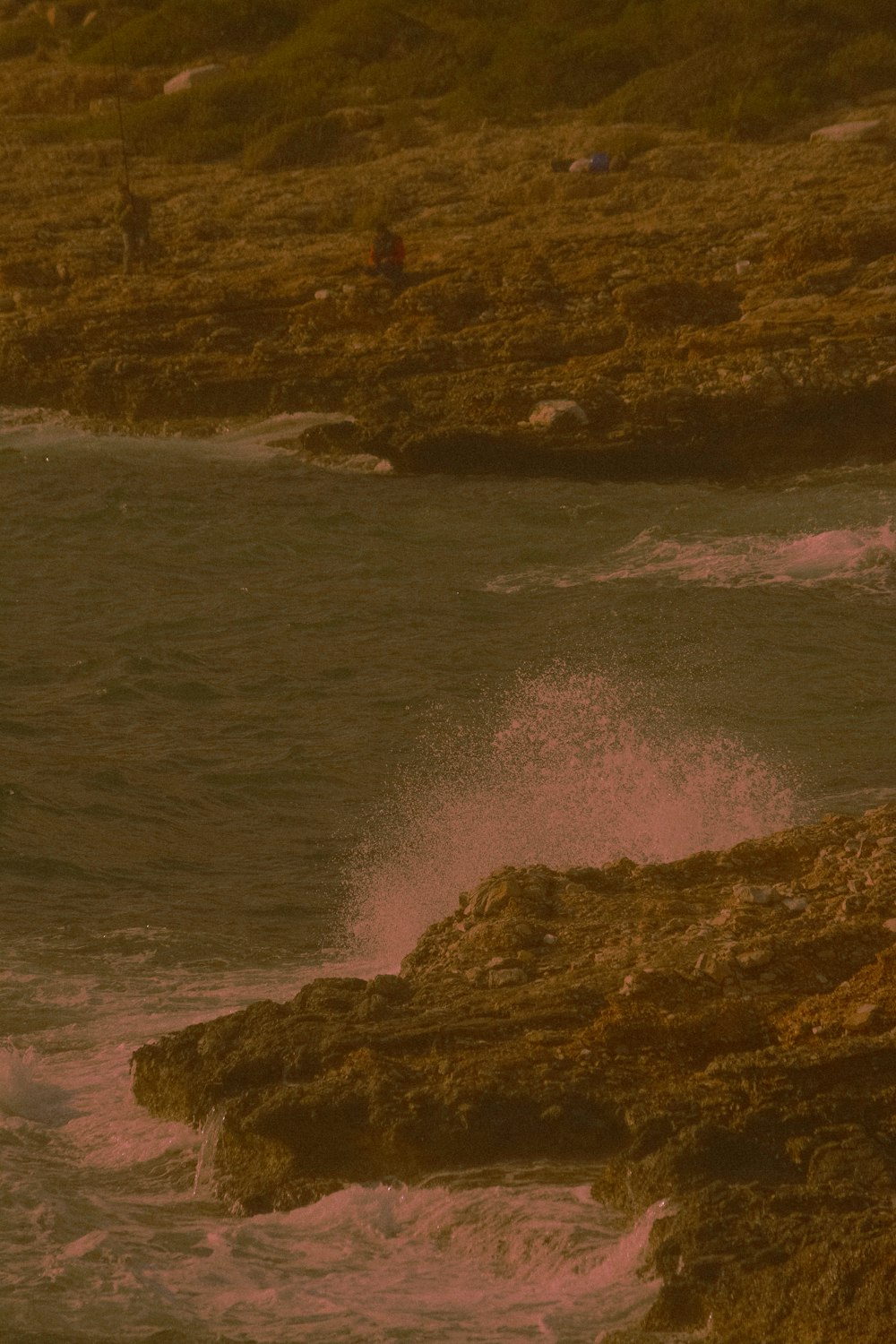 ocean waves crashing on rocky shore during daytime