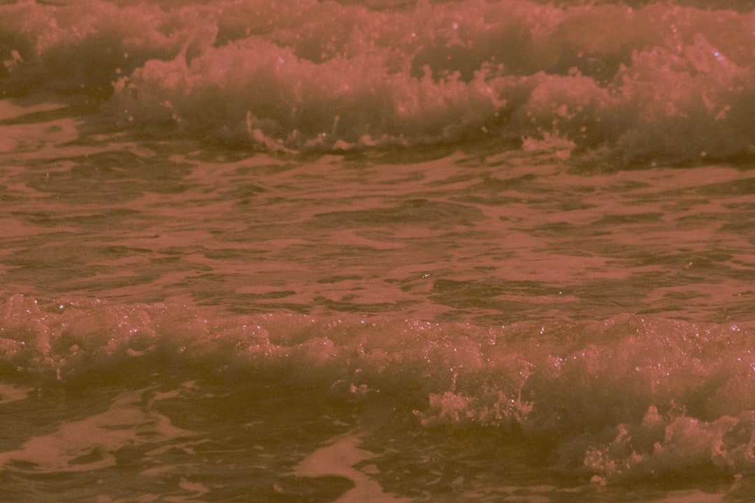 ocean waves crashing on shore during daytime