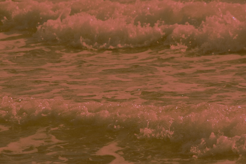 ocean waves crashing on shore during daytime