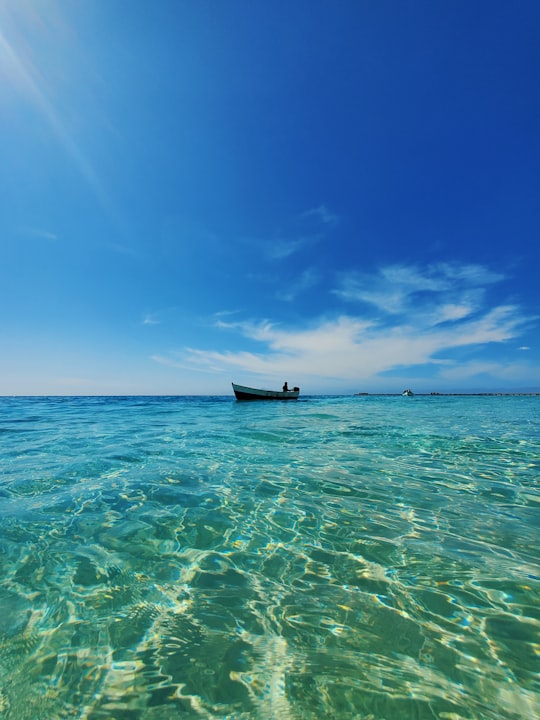 black boat on sea under blue sky during daytime in Maio Cape Verde