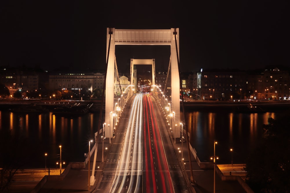 time lapse photography of cars on bridge during night time