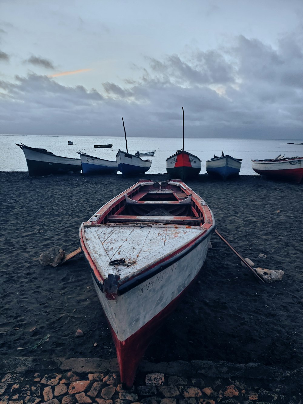 white and red boat on beach during daytime