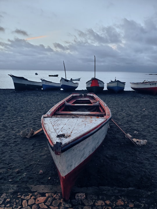 white and red boat on beach during daytime in Maio Cape Verde