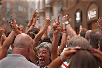 people raising their hands during daytime