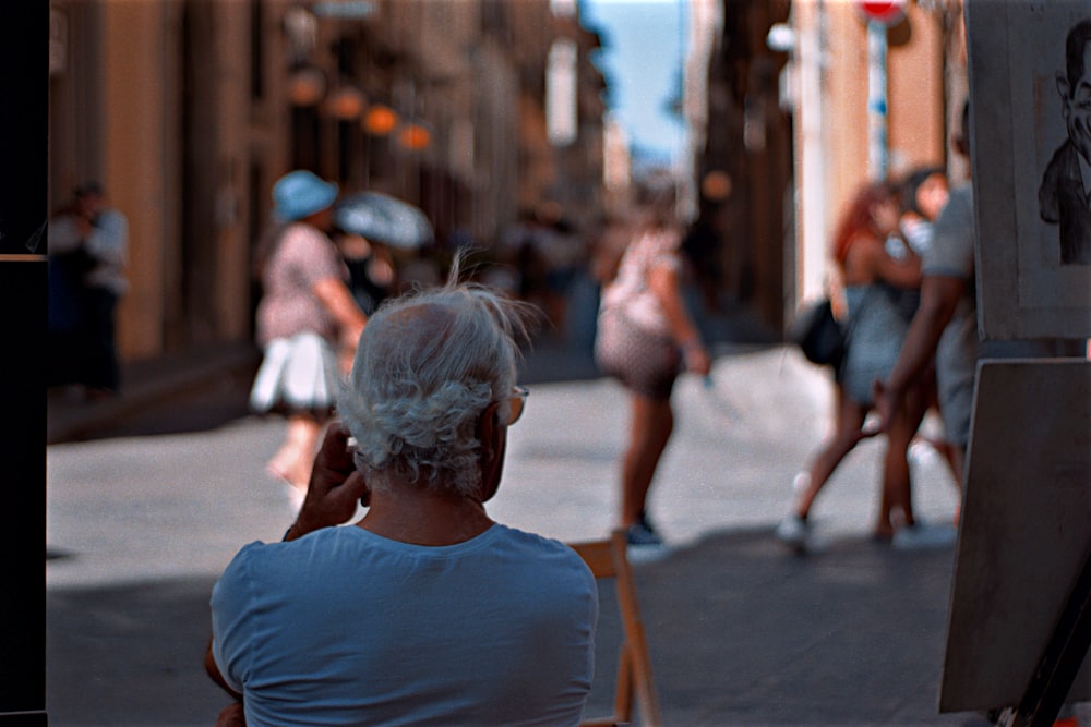 woman in blue tank top walking on street during daytime