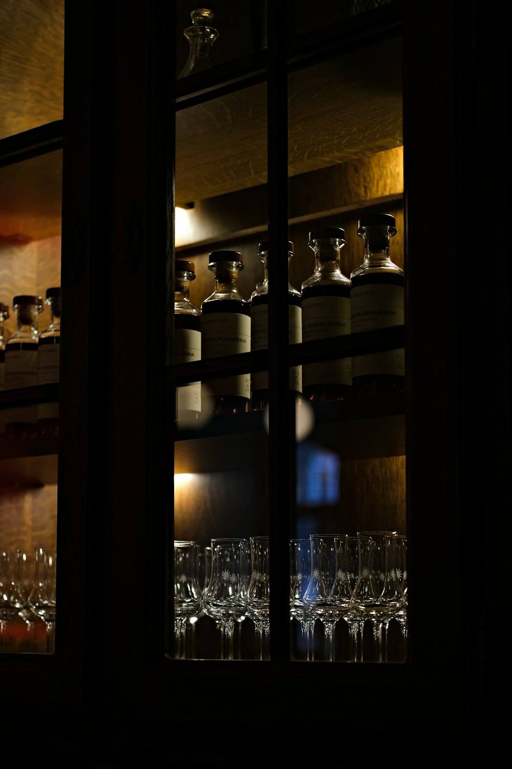 clear drinking glasses on brown wooden shelf