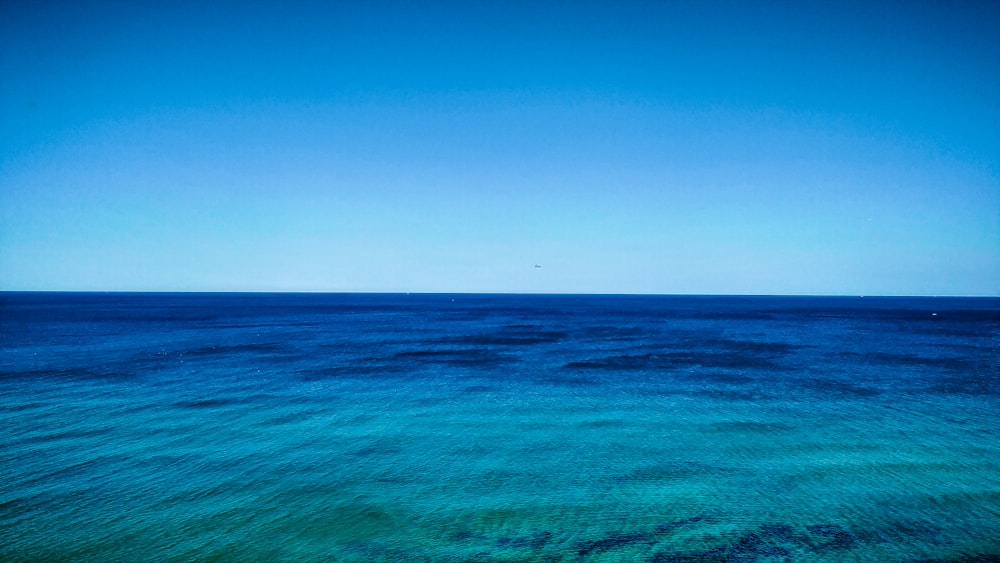 blue ocean water under blue sky during daytime