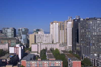 A vibrant cityscape showing modern residential and commercial buildings under a clear sky.