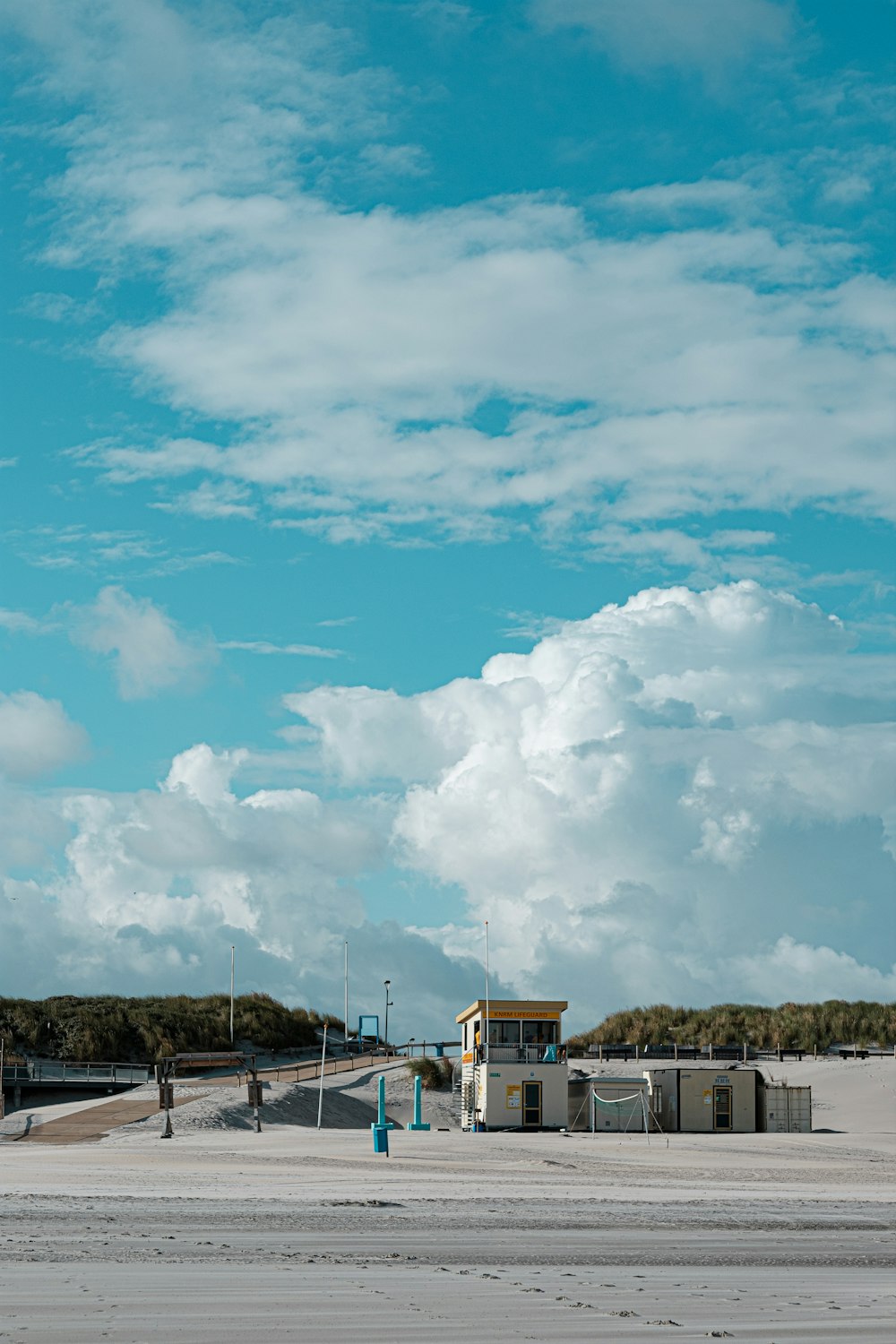 Casa blanca y marrón bajo el cielo azul y nubes blancas durante el día