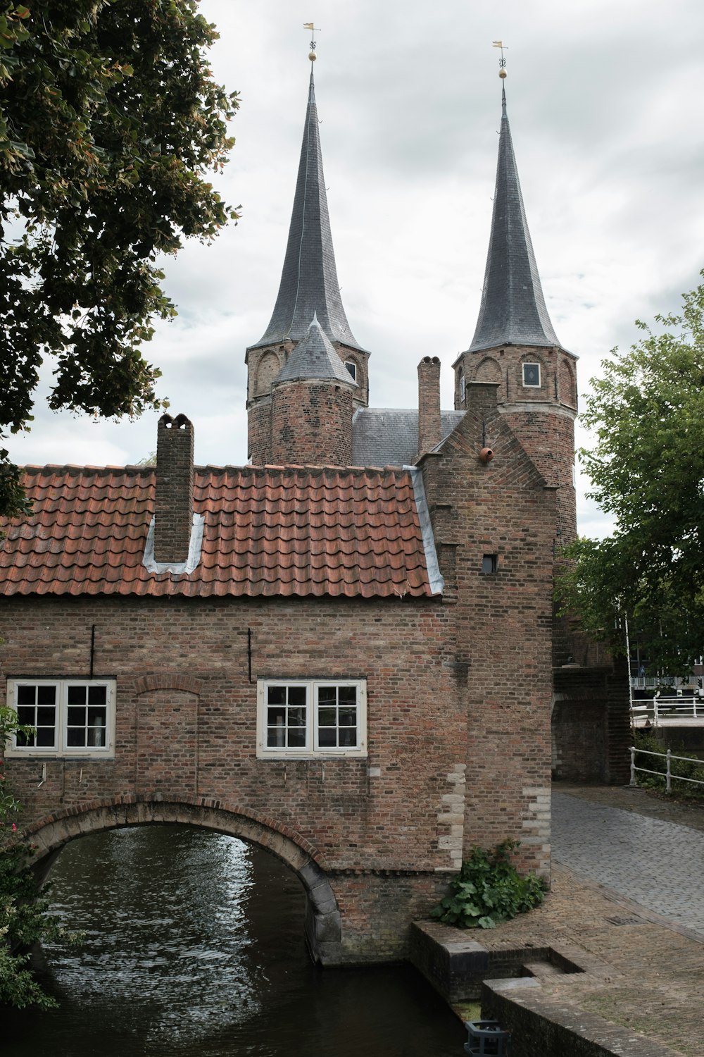 brown brick building near green trees during daytime