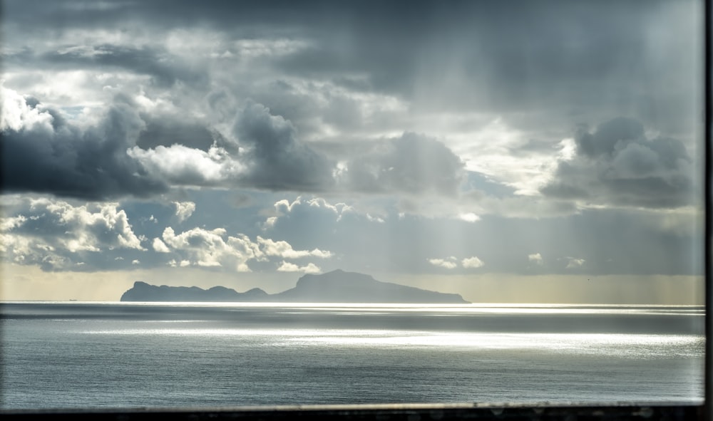 body of water under cloudy sky during daytime