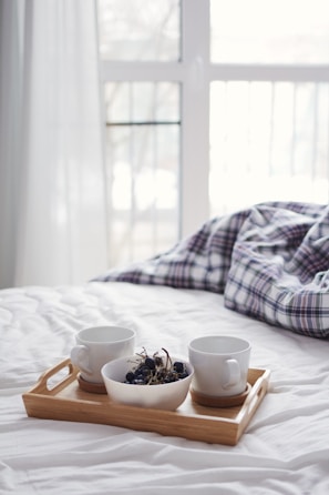 white ceramic mug on brown wooden table