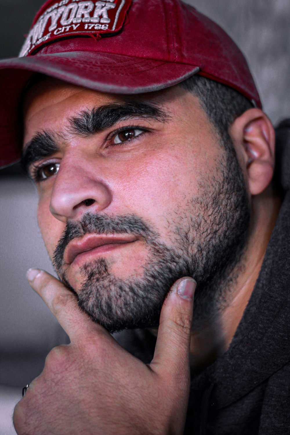 man in black shirt wearing red cap