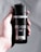 A hand holds a black canister of AXE deodorant and body spray with 'Fresher for Longer' and '48H Fresh' labels. The can is sleek and minimalist in design, featuring bold, white text.