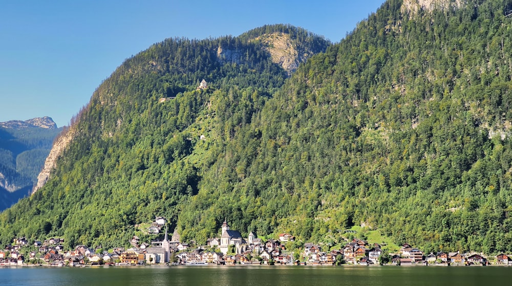 green mountain beside body of water during daytime