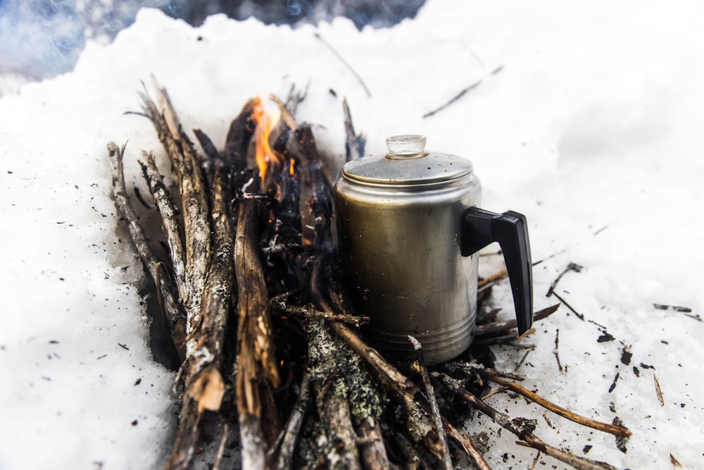 white ceramic teapot on fire