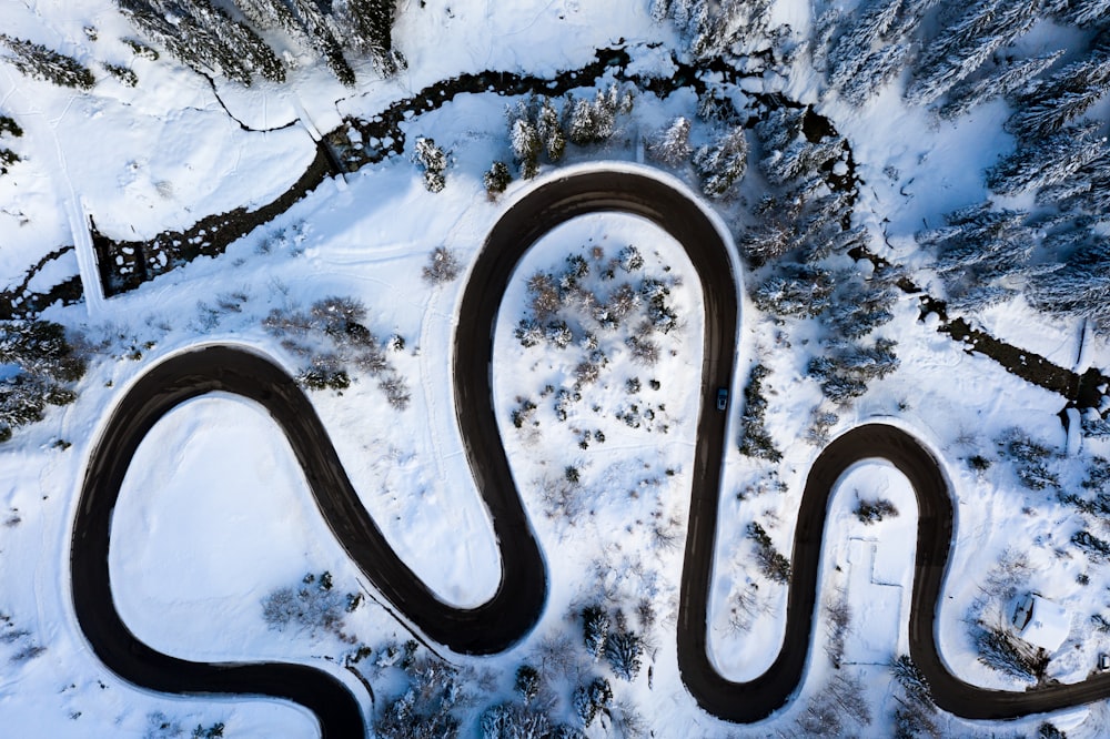 aerial view of road in the middle of snow covered ground