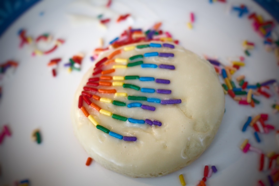 white cake with multi colored sprinkles on white ceramic plate