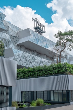 white concrete building near green trees during daytime